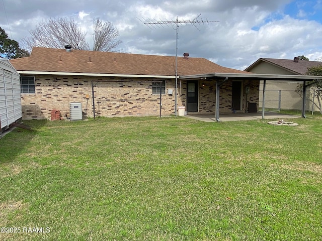 back of property with a lawn and central air condition unit