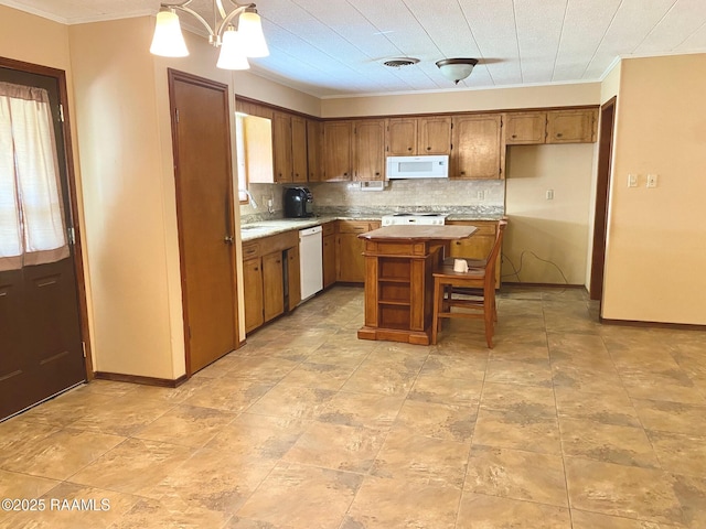 kitchen with visible vents, brown cabinets, tasteful backsplash, white appliances, and light countertops