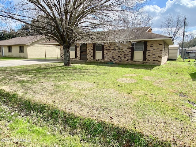 single story home with brick siding and a front yard