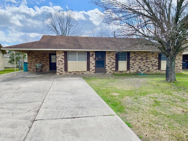 ranch-style house with a carport, brick siding, and a front lawn