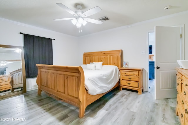 bedroom featuring ceiling fan, ornamental molding, and light hardwood / wood-style flooring