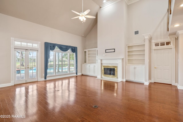 unfurnished living room with ceiling fan, a high end fireplace, high vaulted ceiling, and hardwood / wood-style floors