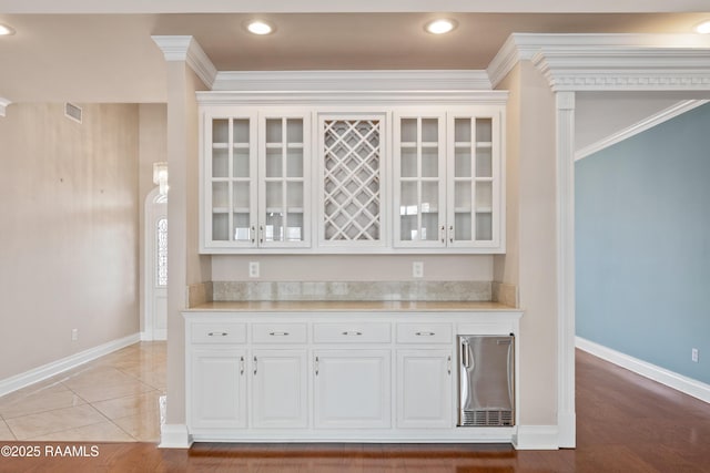 kitchen with ornamental molding and white cabinets