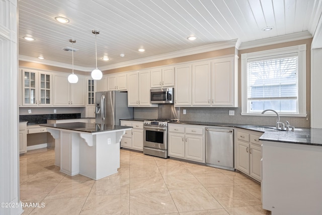 kitchen featuring white cabinetry, sink, hanging light fixtures, a center island, and stainless steel appliances