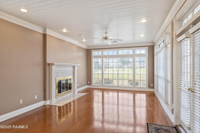 unfurnished living room with crown molding, ceiling fan, a fireplace, and light hardwood / wood-style floors