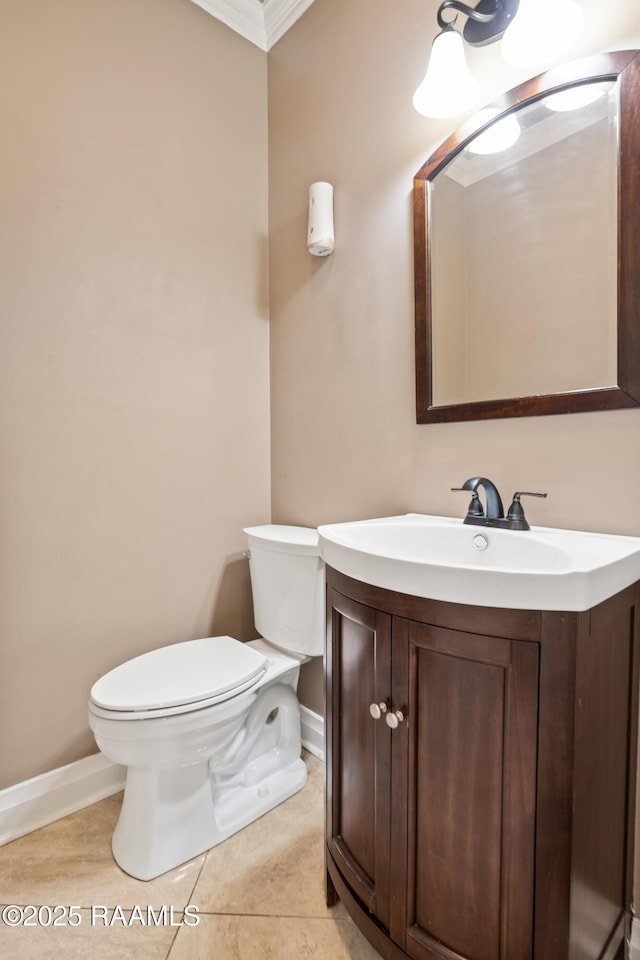 bathroom featuring vanity, tile patterned flooring, crown molding, and toilet