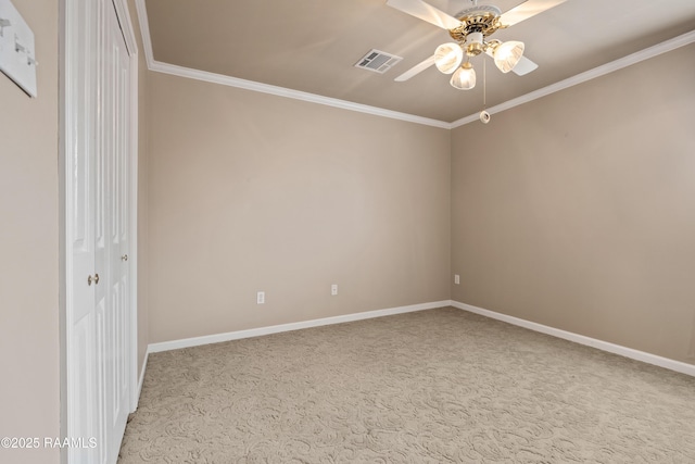 empty room with crown molding, ceiling fan, and carpet flooring