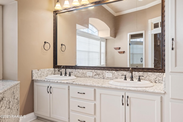 bathroom featuring crown molding and vanity