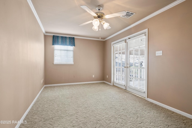 carpeted spare room with ceiling fan and ornamental molding