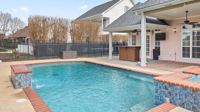 view of swimming pool featuring pool water feature, ceiling fan, and a patio area