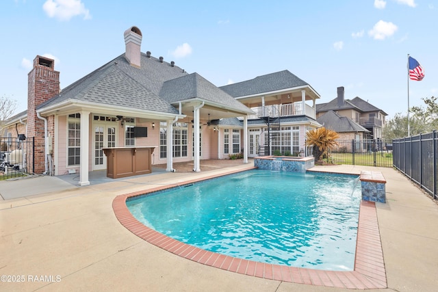 view of pool featuring pool water feature, a patio, ceiling fan, and french doors