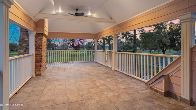 patio terrace at dusk featuring a porch and ceiling fan