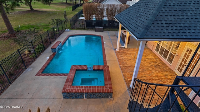 view of pool with an in ground hot tub, pool water feature, a yard, and a patio