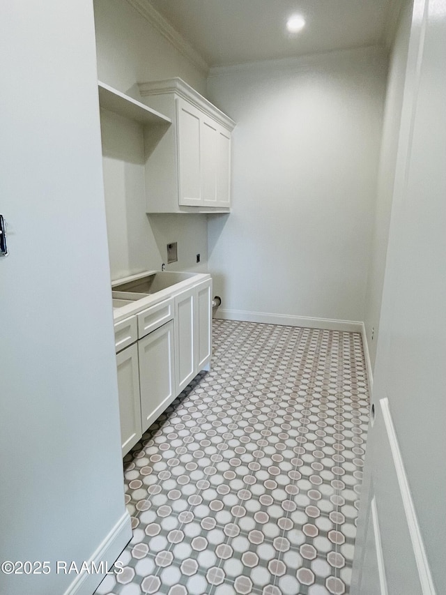 clothes washing area featuring sink, cabinets, ornamental molding, electric dryer hookup, and washer hookup