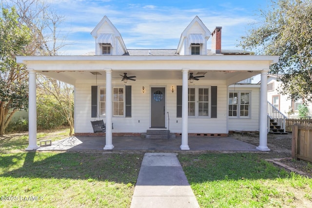 bungalow-style house featuring ceiling fan, a patio, and a front yard