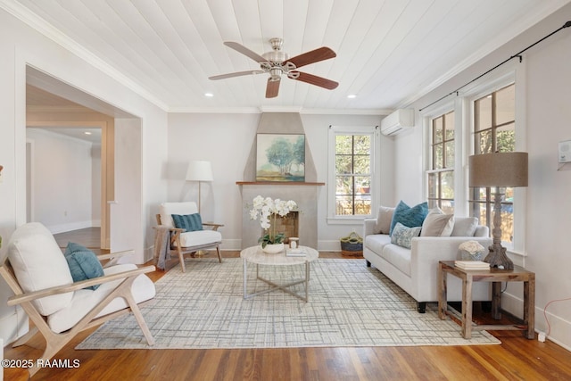 sitting room featuring wooden ceiling, light wood-style flooring, baseboards, an AC wall unit, and crown molding