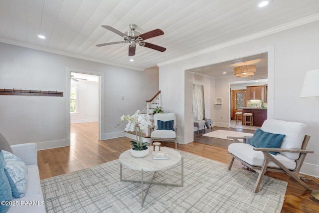 living room featuring recessed lighting, baseboards, light wood-style floors, stairs, and crown molding