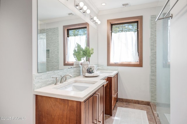 bathroom featuring backsplash, a sink, visible vents, and crown molding