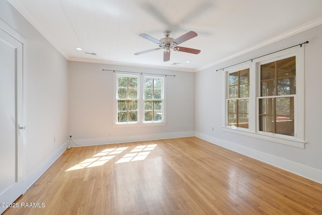 empty room featuring crown molding, light wood-style flooring, baseboards, and ceiling fan