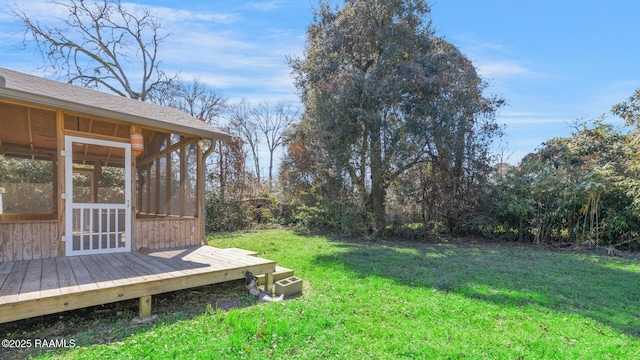 view of yard featuring a deck and a sunroom