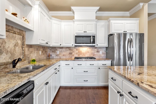 kitchen with light stone countertops, white cabinetry, appliances with stainless steel finishes, and sink