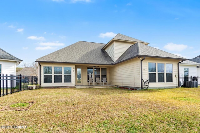 rear view of property with a yard and a patio area