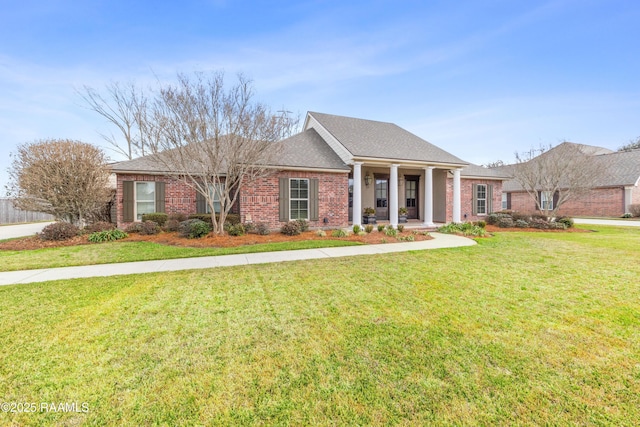 view of front of home featuring covered porch and a front lawn