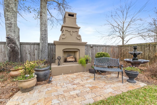 view of patio featuring exterior fireplace