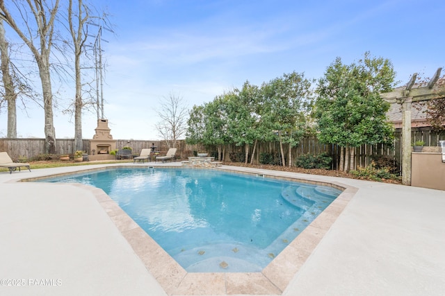 view of swimming pool with a patio area and an outdoor fireplace