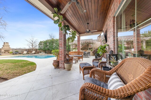 view of patio with a fenced in pool and ceiling fan