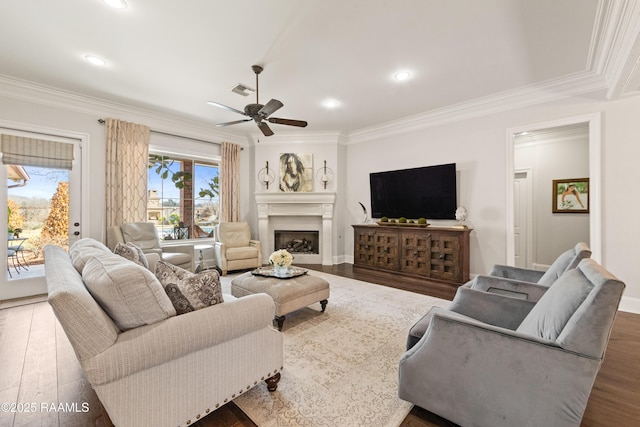 living room featuring crown molding, ceiling fan, and dark hardwood / wood-style flooring