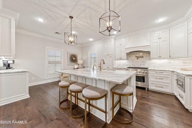 kitchen featuring white cabinetry, stainless steel range, and wall chimney range hood