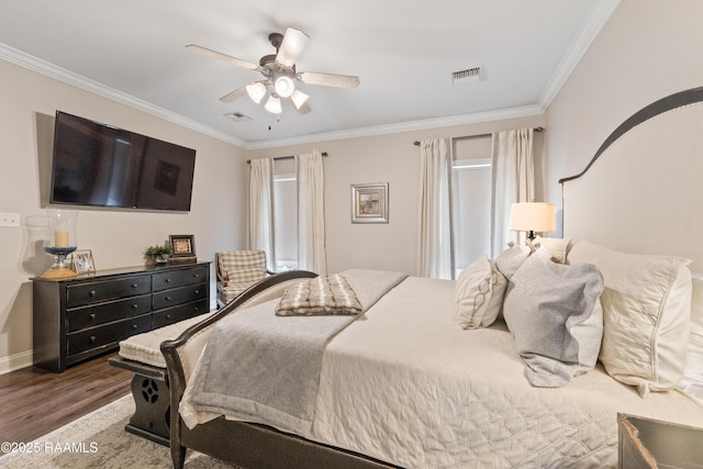 bedroom with dark wood-type flooring, ceiling fan, and crown molding