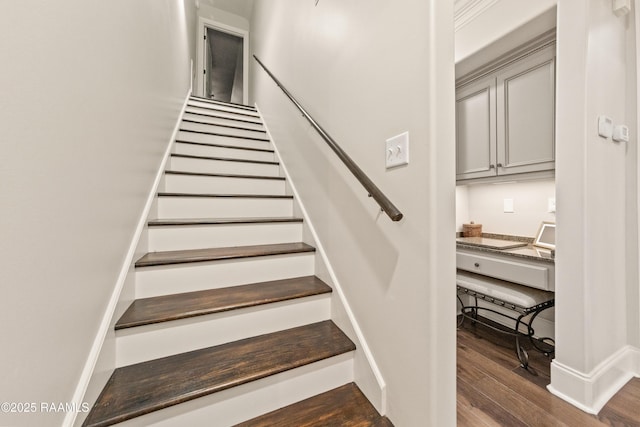 staircase with wood-type flooring and built in desk