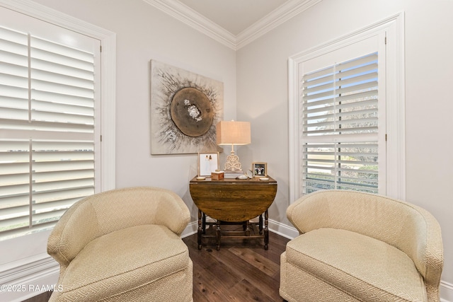 sitting room featuring ornamental molding and dark hardwood / wood-style flooring