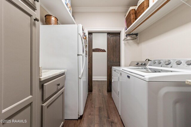 laundry area featuring separate washer and dryer, ornamental molding, and dark hardwood / wood-style floors