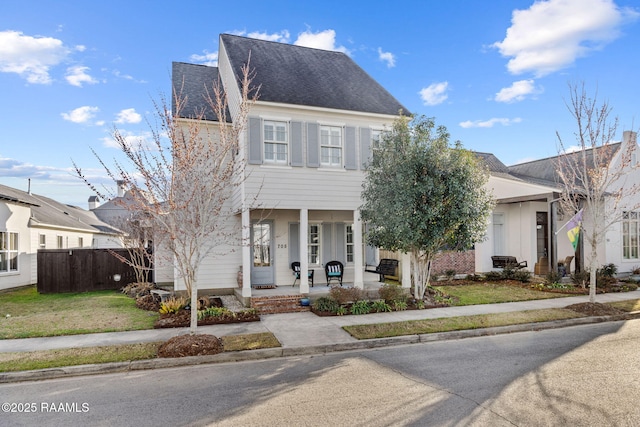 view of front of property with covered porch and a front lawn