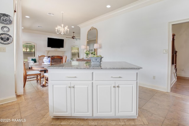 211 Bayonne Dr, Lafayette, LA 70507 - kitchen featuring crown molding, a ceiling fan, light stone counters, a chandelier, and white cabinets