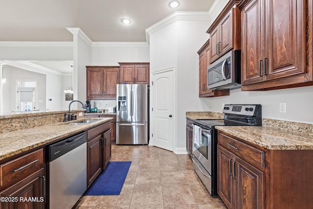 kitchen with sink, crown molding, stainless steel appliances, light stone countertops, and decorative light fixtures