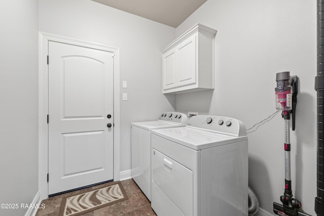 laundry room featuring cabinets and washing machine and dryer