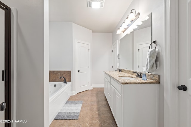 bathroom featuring vanity and a washtub