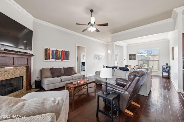 living room featuring ornamental molding, dark hardwood / wood-style floors, and ceiling fan with notable chandelier