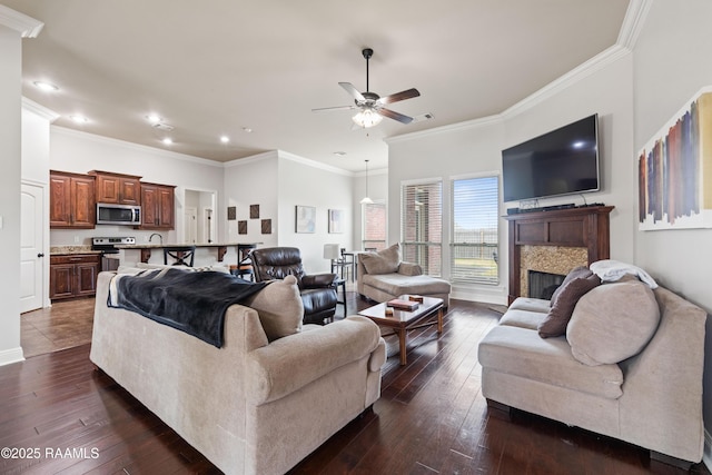 living room featuring ornamental molding, dark hardwood / wood-style floors, and ceiling fan