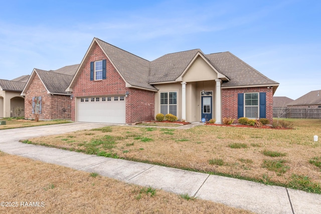 view of front of home featuring a garage and a front yard