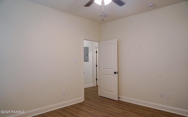 unfurnished room featuring dark hardwood / wood-style flooring, electric panel, and ceiling fan