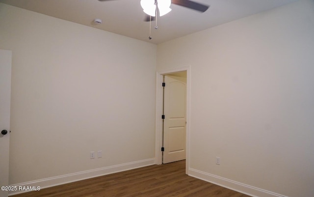 spare room featuring ceiling fan and dark hardwood / wood-style flooring