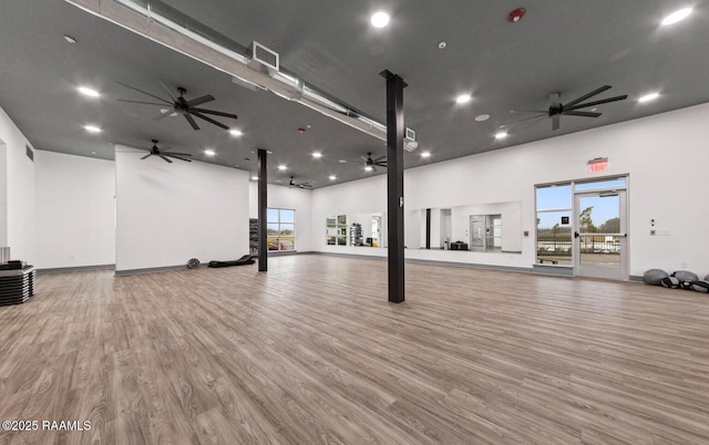 interior space with hardwood / wood-style flooring and a high ceiling