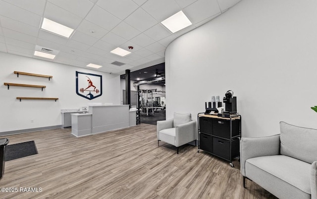 living area featuring light hardwood / wood-style flooring and a drop ceiling