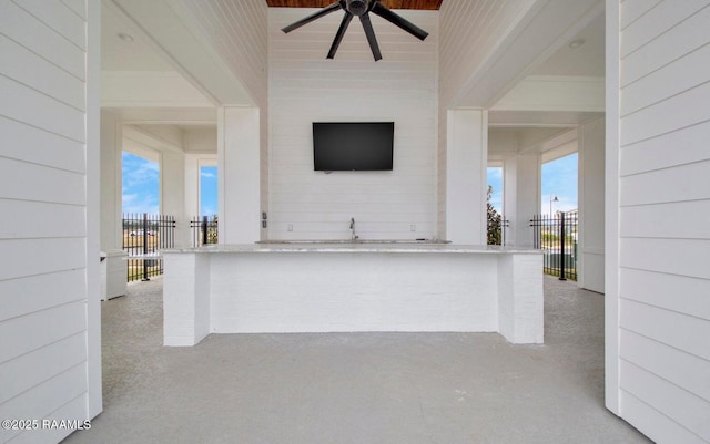 view of patio / terrace with exterior bar and ceiling fan