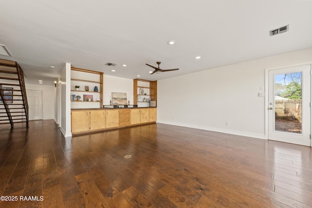 unfurnished living room with ceiling fan and dark hardwood / wood-style flooring